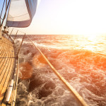 Sailing yacht against sunset. Luxury yachts.